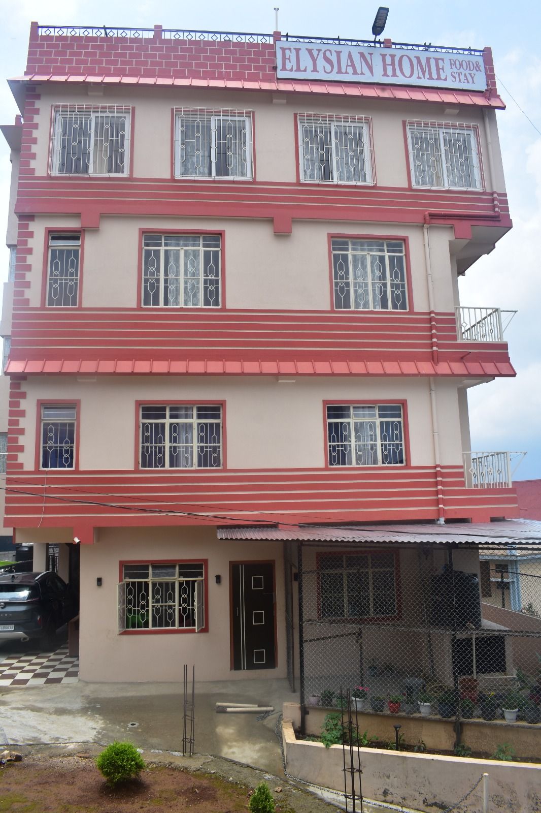 Homestay Facade & Paved Grounds